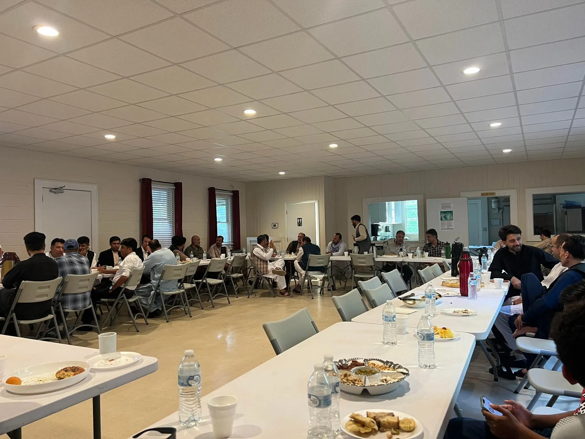 Community members sharing a meal together at a Maihan Association dinner.