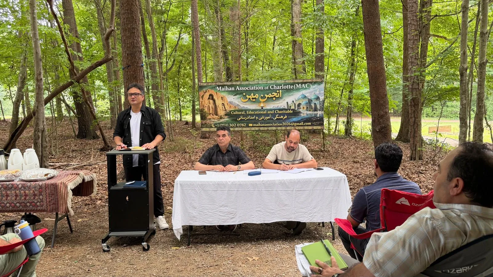 Maihan Association members gathered beneath the association banner at a community meeting in Charlotte.