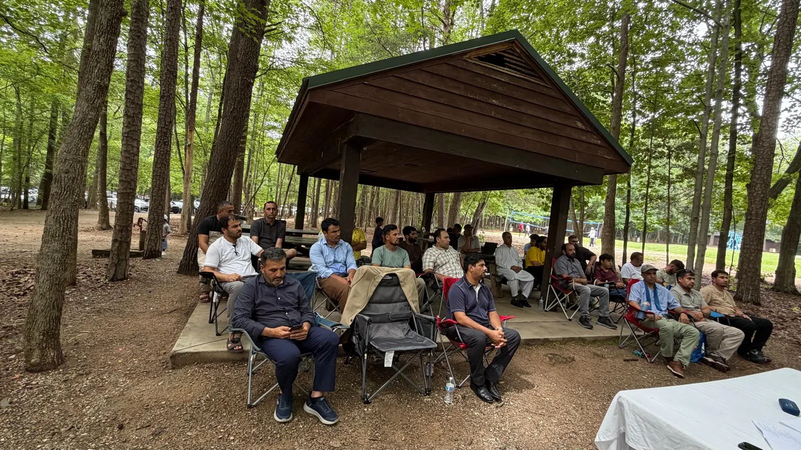 Families gathered under a picnic shelter at a Maihan Association outing.