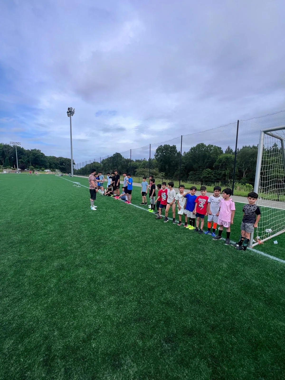 Young players at the goal line during a Maihan Association soccer practice.